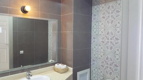 a bathroom with a sink and a mirror at Imsouane Magic House in Imsouane