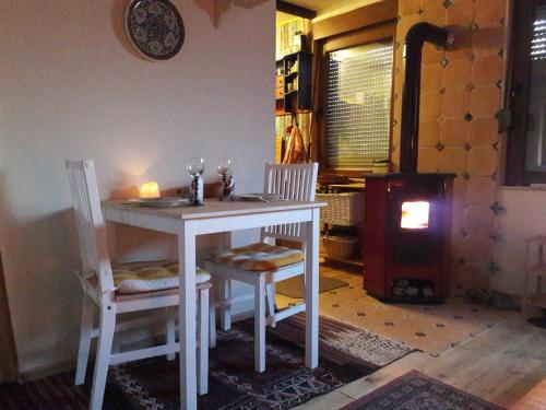 a kitchen with a table and chairs and a stove at Urlaub am Auberg in Gerolstein