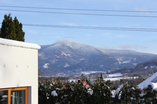 a view of a snow covered mountain from a house at Vila Apalucha49 Čeladná - 12 osob in Čeladná
