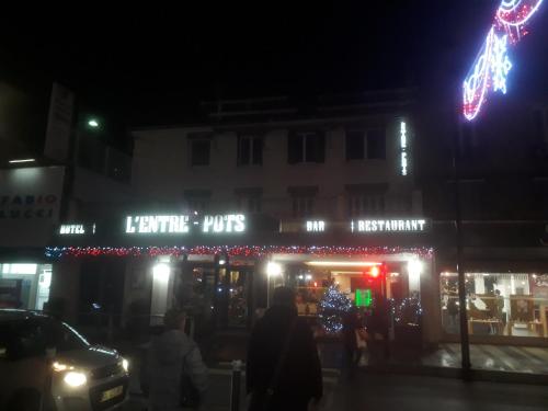 a store with christmas lights in front of it at night at L'ENTRE-POTS in Sartrouville
