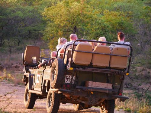 a group of people riding in the back of a jeep at Kingfisher Creek Safari Lodge in Hoedspruit