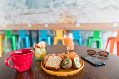 a plate of bread and a cup of coffee on a table at Ibis Styles Hyères Rooftop & Spa in Hyères