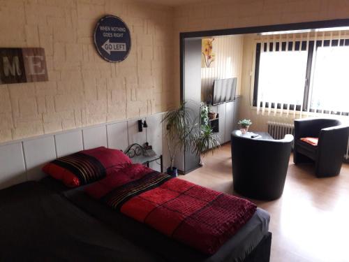 a bedroom with a bed and a living room at Pension Hubertus in Oberraden