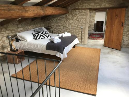 a bedroom with a bed in a stone building at Sotto I Sassi in Guiglia