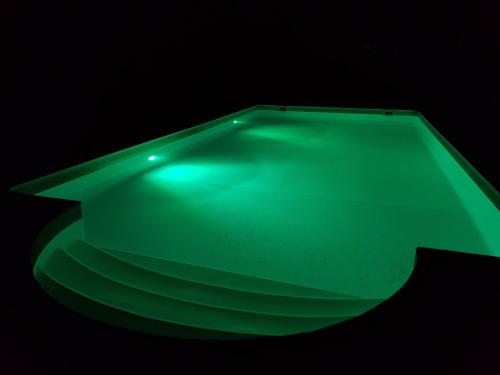 a green table in a dark room at Villa Eden Vert in Fayence