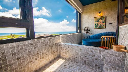 a room with a view of the ocean through windows at Liuqiu Antique Tea House in Xiaoliuqiu