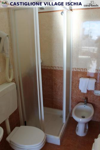 a bathroom with a shower and a toilet and a sink at Hotel Castiglione in Ischia