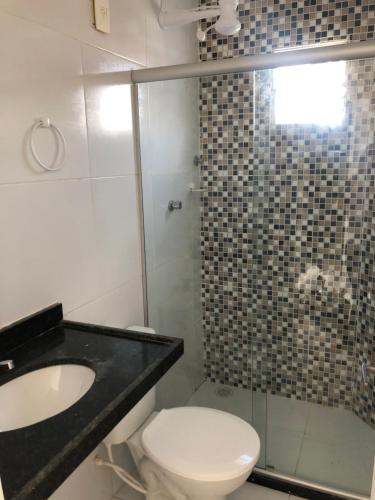 a bathroom with a toilet and a sink and a shower at Edf. Dom João in São José da Coroa Grande