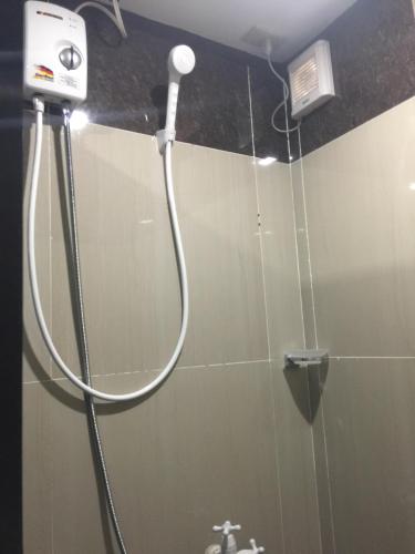 a shower with a shower head in a bathroom at Pitaya Native Guest House in Panglao