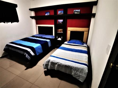 two beds sitting next to each other in a bedroom at Mi Depa Tec 5 in Monterrey