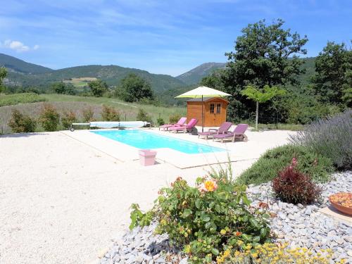 a swimming pool with two chairs and a gazebo at LES HAUTS DE JALLIA in Sainte-Jalle