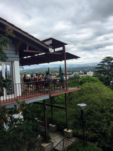 a group of people sitting at a table on a deck at Casa Alta Hotel Boutique & Spa - Solo Adultos in Villa Carlos Paz