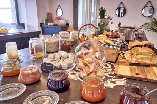 a table topped with lots of different types of food at Belfry & Spa by Ligne St Barth in Lourdes