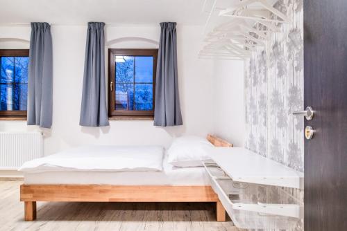 a bedroom with a bed and a window at Chata Krušnohorka in Kovářská