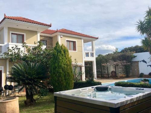 a house with a hot tub in the yard at Villa Soula in Anavissos