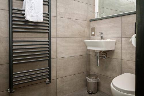 a bathroom with a sink and a toilet at Woolpack Inn in Eskdale
