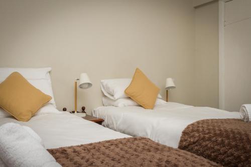 two beds sitting next to each other in a room at Woolpack Inn in Eskdale