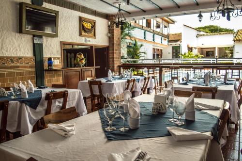 a restaurant with tables with white tablecloths at Hotel El Virrey Boutique Honda in Honda