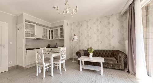 a living room with a couch and a table at Górska Legenda Apartamenty & Domki in Szczyrk