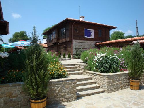 a large stone building with a stone wall at Voevodski Eco Complex in Katunishte