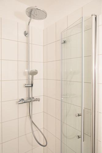 a shower with a shower head in a bathroom at Smaaland in Flensburg