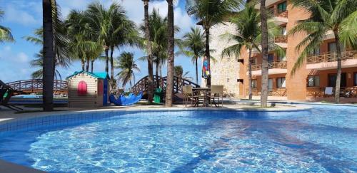 a large swimming pool in front of a resort at Manacá Apartamentos , Kariri Beach , Cumbuco in Cumbuco