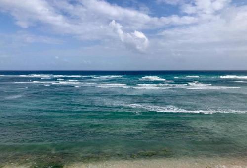 a view of the ocean from the beach at Deluxe New Beachfront Penthouse in Akumal in Akumal