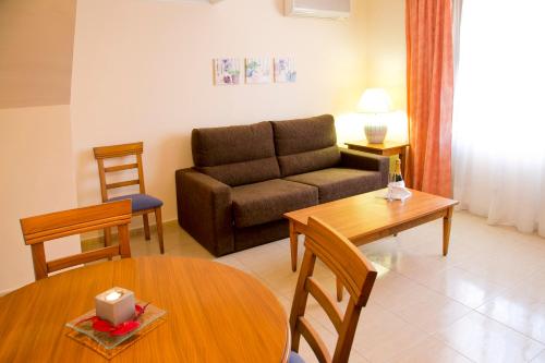 a living room with a couch and a table at Aparthotel Bahia Pinosol in Jávea