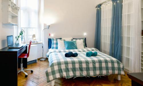 a bedroom with a bed with a desk and a computer at Large and cozy Apartment 60 m2, Cracow Old Town in Krakow