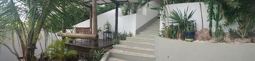 a set of stairs leading up to a house with plants at Pousada Passagem dos Papagaios in Cabo Frio