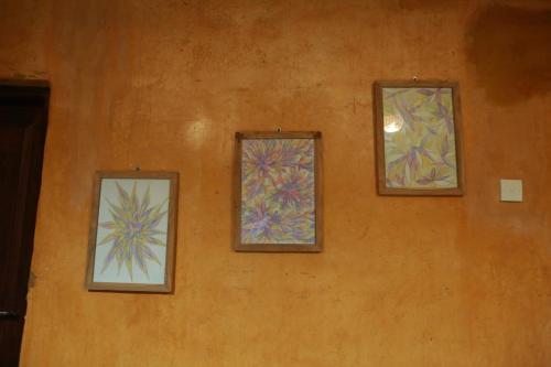 three stained glass windows on the side of a wall at Limecabanas-srilanka in Galle
