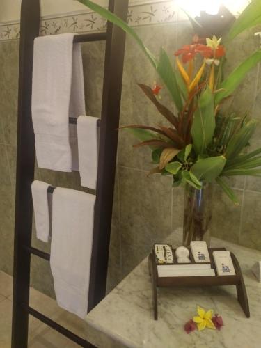 a towel rack in a bathroom with towels at Bali Paradise Hotel Boutique Resort in Lovina