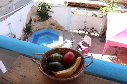 a basket of fruit on a table on a balcony at La Jungla in Olón