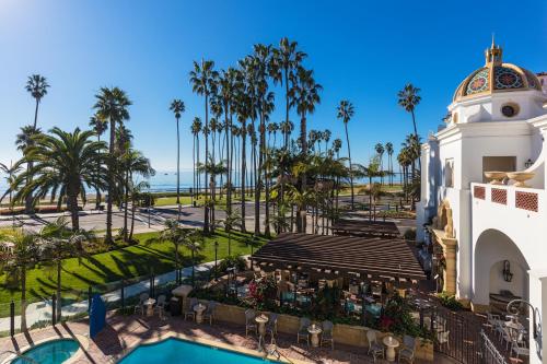 an aerial view of a resort with a pool and palm trees at Santa Barbara Inn in Santa Barbara