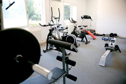 a gym with several exercise bikes in a room at Aparthotel Bahia Pinosol in Jávea