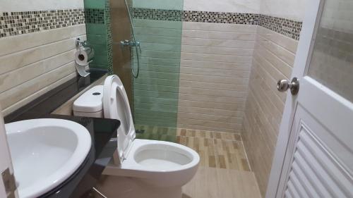 a bathroom with a toilet and a sink and a shower at JP Resort Koh Tao in Koh Tao
