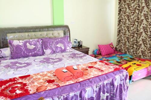 1 dormitorio con cama con chanclas en Yulia Resort en Sabong