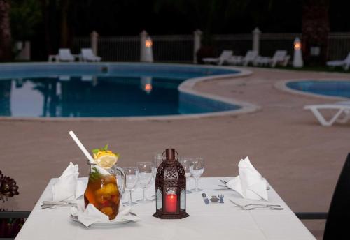 a table with a bottle of wine and glasses on it at Turiquintas in Armação de Pêra