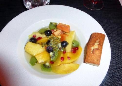 a white plate of food with fruit and vegetables at Matoppo Inn in Beaufort West