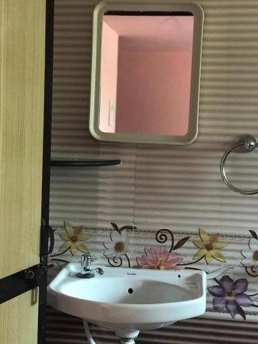 a bathroom with a sink and a mirror at All Seasons Guest House in Vasco Da Gama