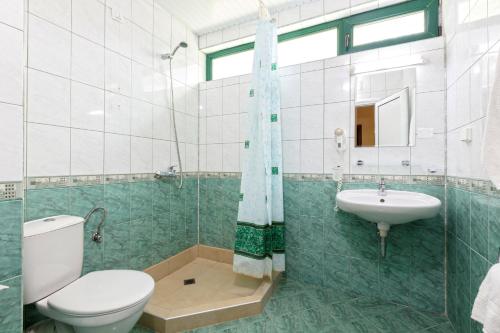 a bathroom with a toilet and a sink at Hotel L&B- Free parking in Sunny Beach