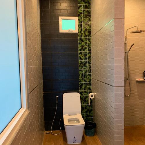 a bathroom with a toilet and a shower at Vipa Tropical Resort in Ao Nang Beach