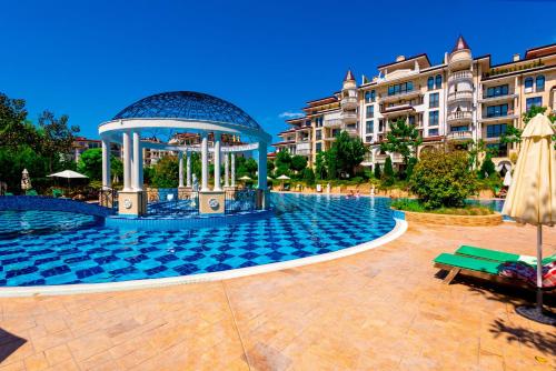 a swimming pool with a gazebo in front of a building at Poseidon VIP Residence Club Balneo & SPA Resort in Nesebar