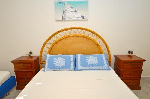 a bedroom with a bed with blue pillows on it at Casa Baia Tramonto in Patù