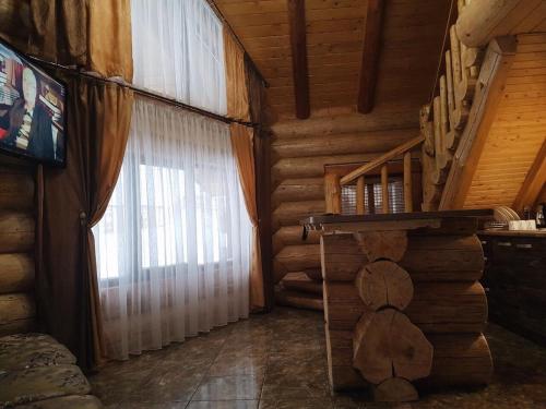 a room with a window in a log cabin at Зимова казка in Tatariv