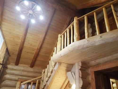 a wooden staircase in a cabin with a wooden ceiling at Зимова казка in Tatariv