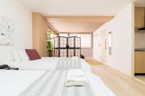 Ένα ή περισσότερα κρεβάτια σε δωμάτιο στο GuestHouse MIYABI
