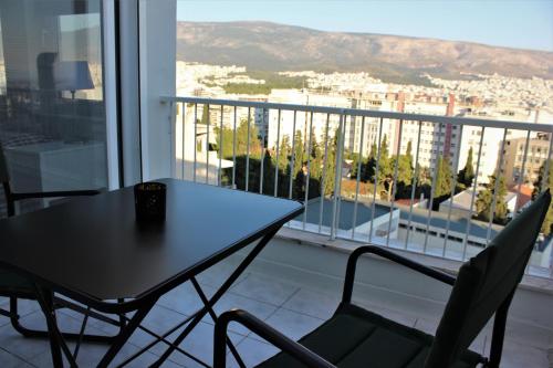 a table and chairs on a balcony with a view at Xenon Loft in Athens