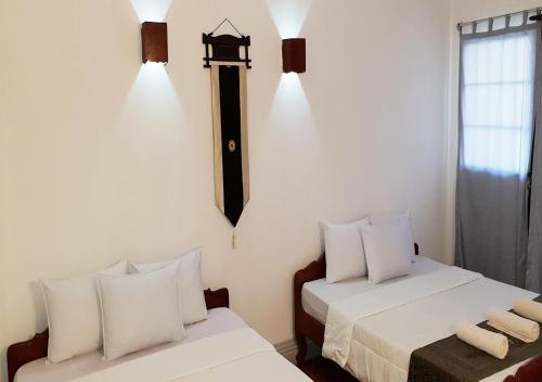 Ein Bett oder Betten in einem Zimmer der Unterkunft Smiley's Guesthouse
