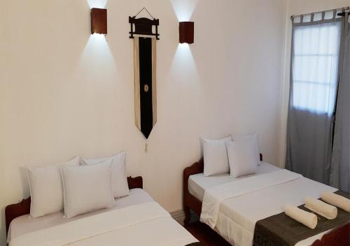 Ein Bett oder Betten in einem Zimmer der Unterkunft Smiley's Guesthouse